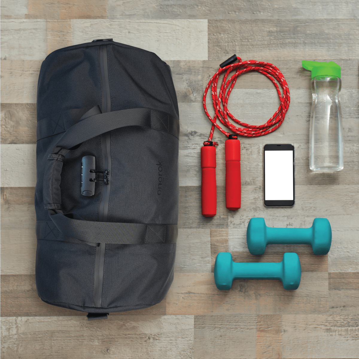 A top-down view shows the Carbon-lined Duffle Bag alongside fitness equipment and a smartphone on a light wood surface.