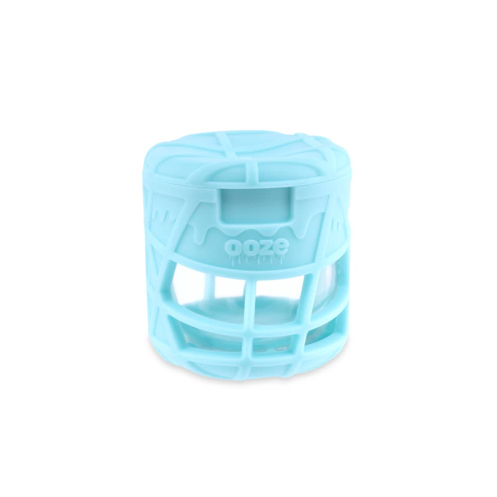 A slightly angled view of the Ooze Prizm Silicone-Wrapped Glass Stash Jar, showing a clear glass container within a protective blue silicone sleeve.