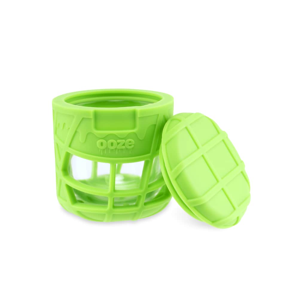 A slightly angled view of the Ooze Prizm Silicone-Wrapped Glass Stash Jar, showing its textured, green silicone exterior.
