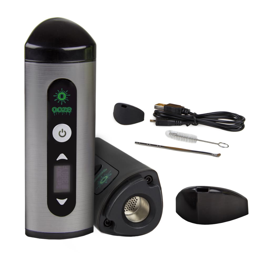 Front view of the Ooze Drought Dry Herb Vaporizer Kit, showcasing its sleek black design and included cleaning brush and charging cable.