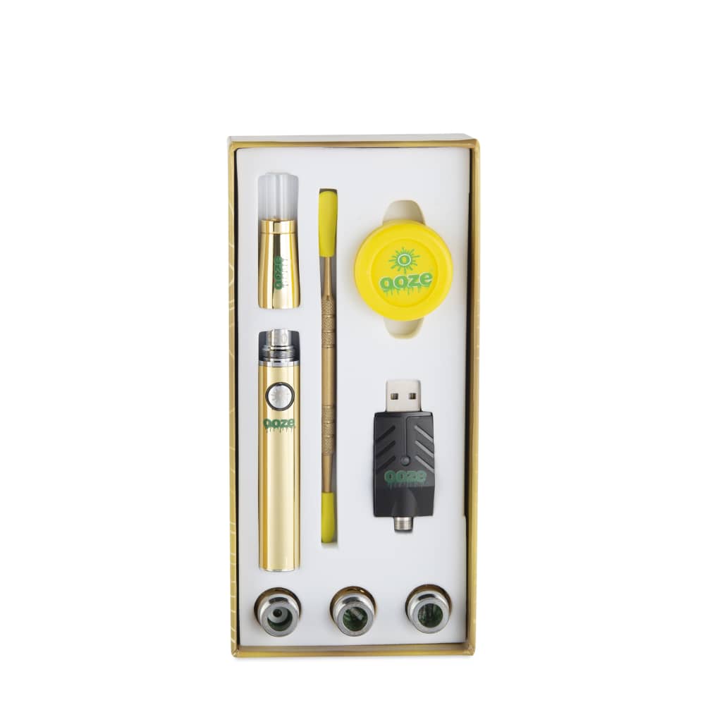 The Ooze Fusion Atomizer Vape Battery is displayed in its open packaging, with the gold-colored battery alongside its accessories.