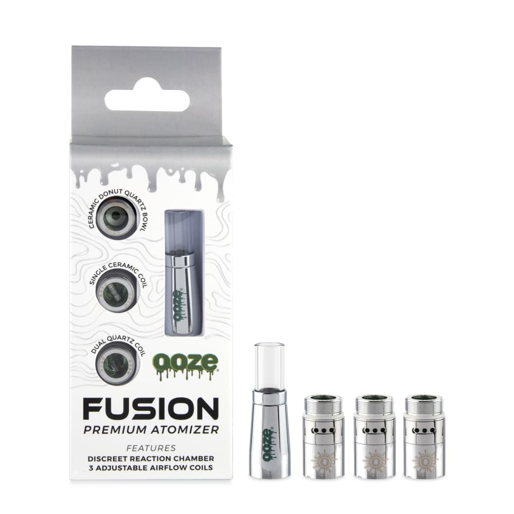 A close-up, angled view of the Ooze Fusion Vape Atomizer on a black surface, showcasing its metallic finish and branding.