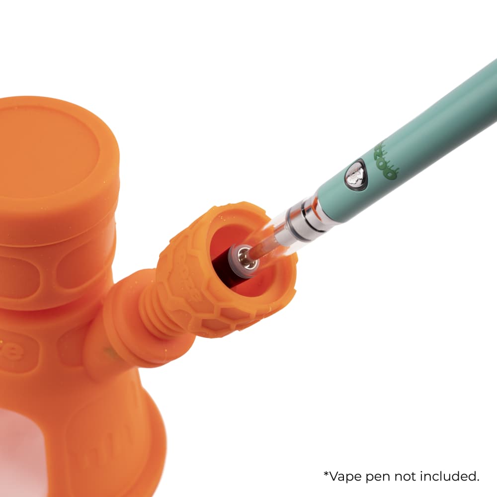 Close-up view of the Ooze Hyborg Silicone Glass 4-in-1 Hybrid Water Pipe and Nectar Collector’s joint, showcasing a green glass tip inserted into the orange silicone.