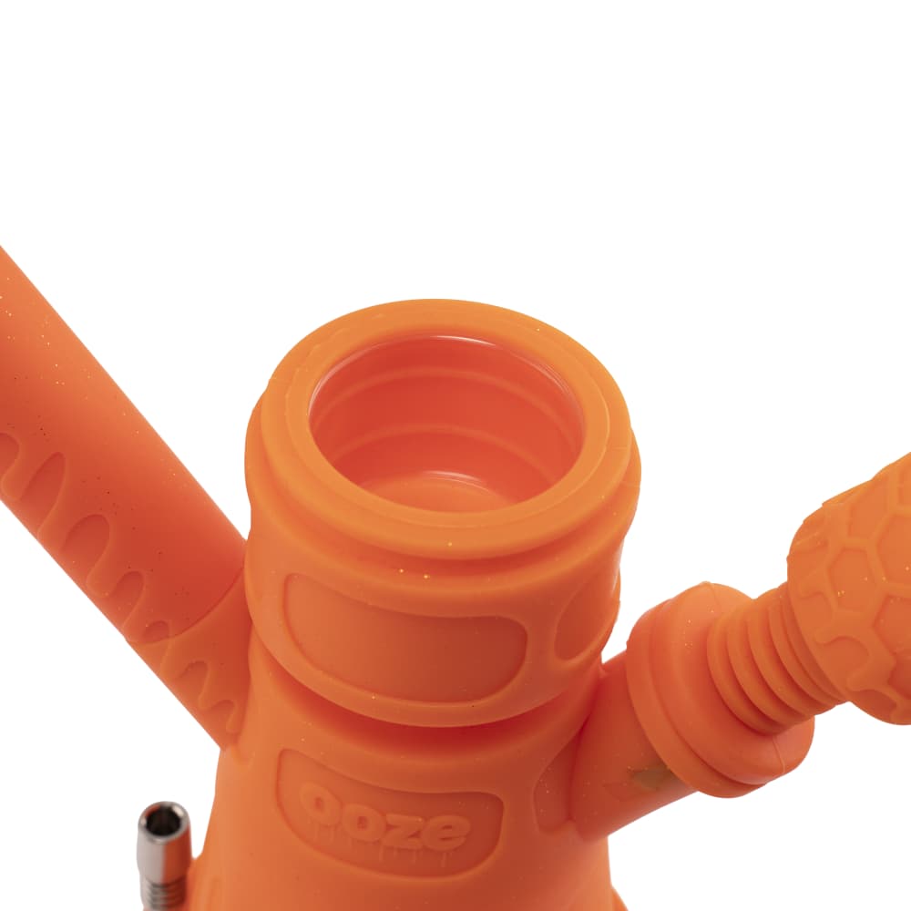 Close-up of the Ooze Hyborg Silicone Glass 4-in-1 Hybrid Water Pipe and Nectar Collector’s mouthpiece, showing the textured silicone and open joint.