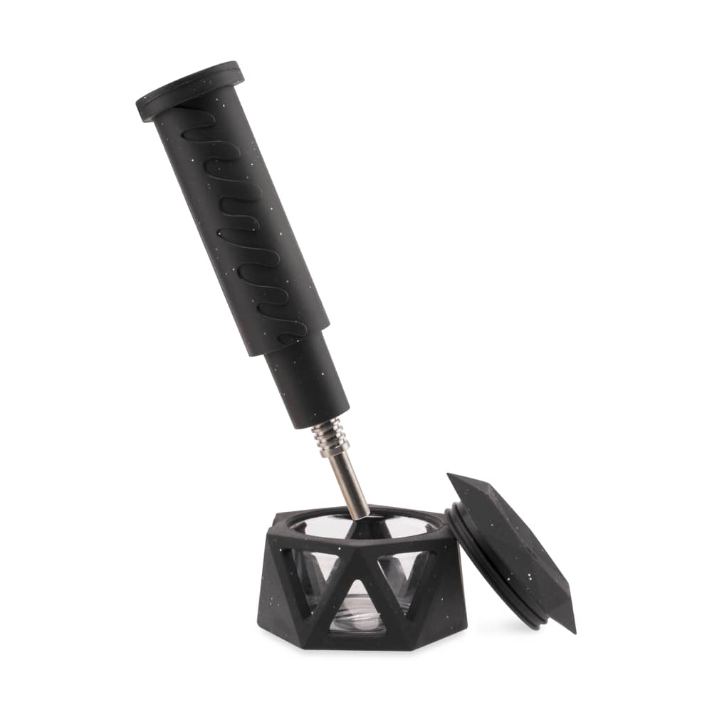 A slightly angled view of the Ooze Hyborg Silicone Glass 4-in-1 Hybrid Water Pipe and Nectar Collector with a dark, geometric base.