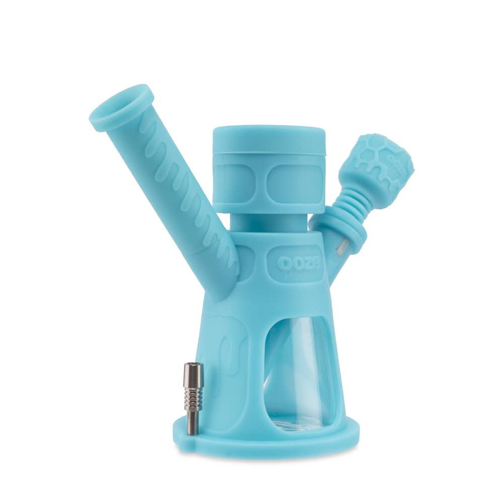 A three-quarter view of the Ooze Hyborg Silicone Glass 4-in-1 Hybrid Water Pipe and Nectar Collector, showcasing its clear glass and silicone construction.