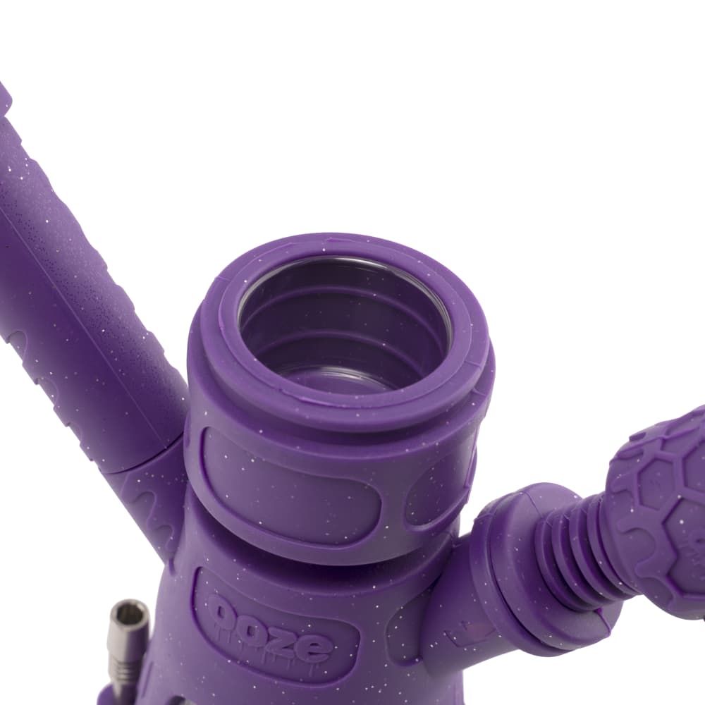 Close-up view of the Ooze Hyborg Silicone Glass 4-in-1 Hybrid Water Pipe and Nectar Collector’s purple mouthpiece, highlighting its textured grip.