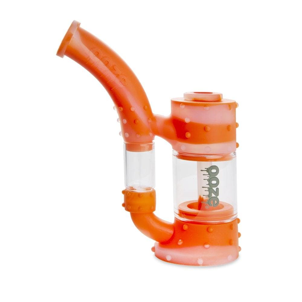 A close-up, angled view of the Ooze Stack Pipe Silicone Bubbler, showcasing its textured orange surface and compact design.