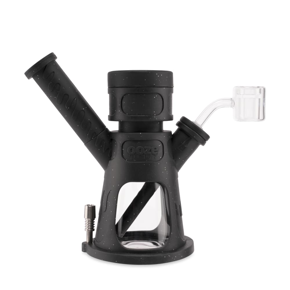 A three-quarter view of the Ooze Hyborg Silicone Glass 4-in-1 Hybrid Water Pipe and Nectar Collector, featuring a dark-colored body and glass mouthpiece.