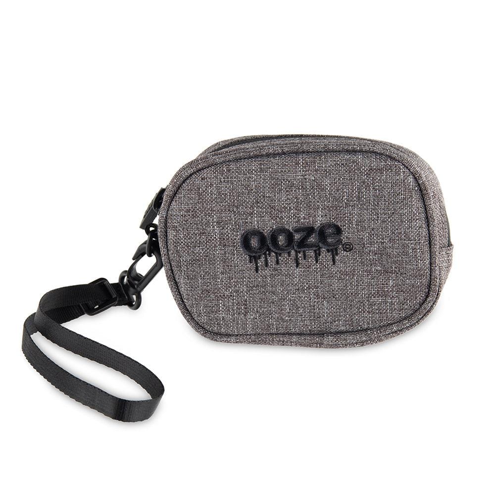 Front view of the Traveler Smell Proof Wristlet - Smoke Gray, showing a closed, textured wristlet with a black strap and metal clip.