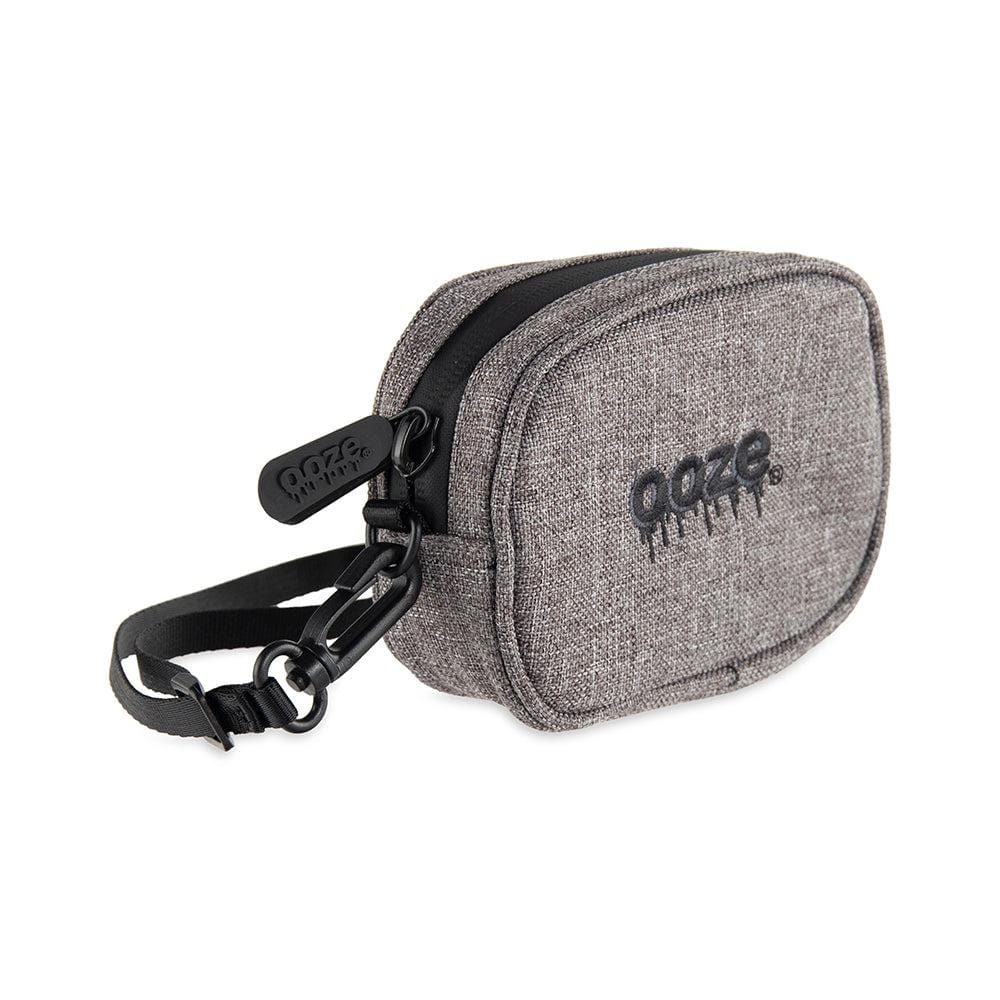 Front view of the Traveler Smell Proof Wristlet - Smoke Gray, showing a zippered pouch with a black carrying strap against a neutral background.