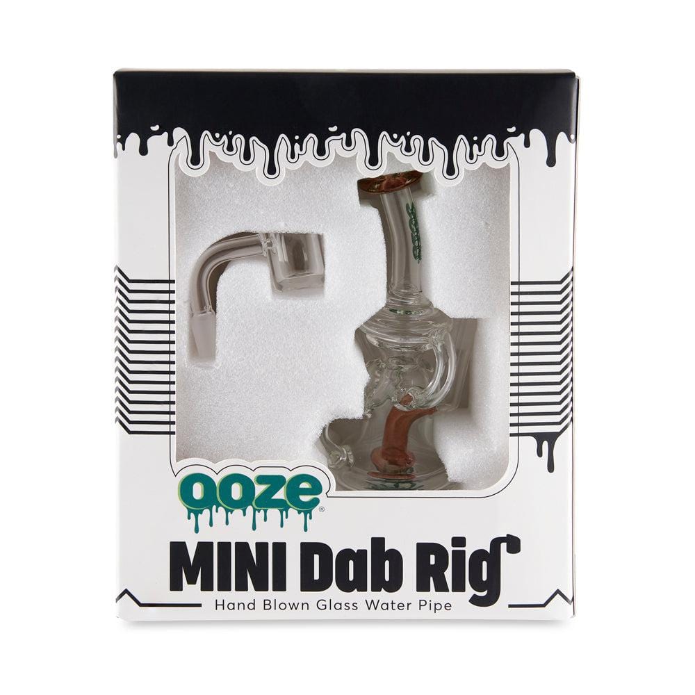 A front view of the Ooze Surge Mini Recycler Dab Rig in clear glass, angled against a black background.