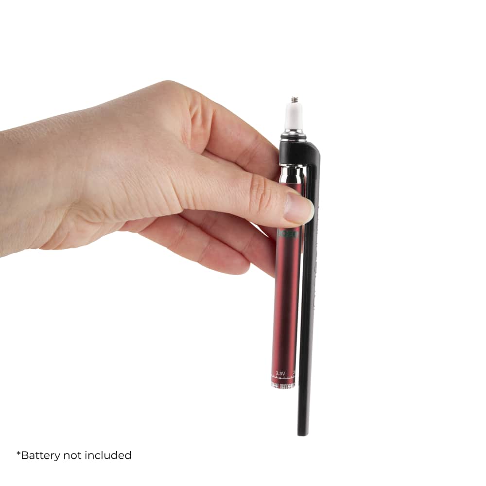 A hand holds the Ooze x Stache ConNectar - 510 Thread Dab Straw Vape Pen Attachment, showcasing its slim, metallic design.