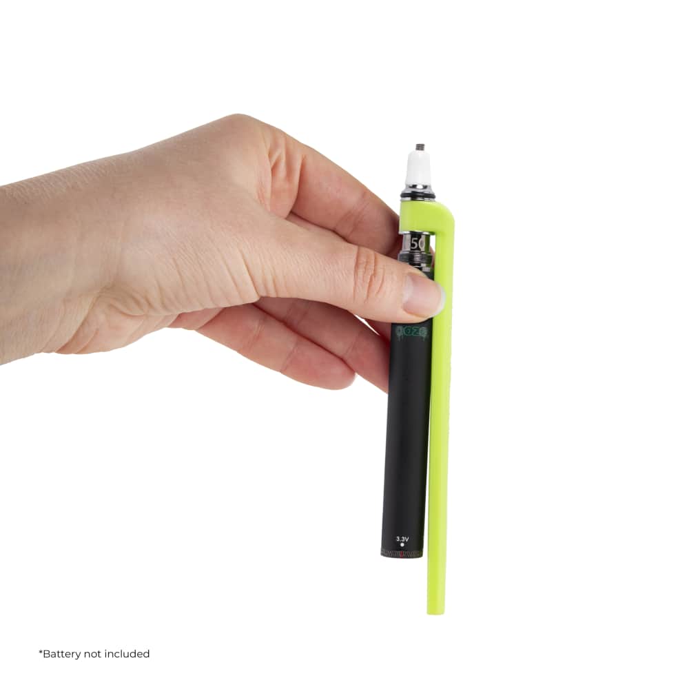 A hand holds the Ooze x Stache ConNectar – 510 Thread Dab Straw Vape Pen Attachment, showing its metallic tip and sleek cylindrical design.