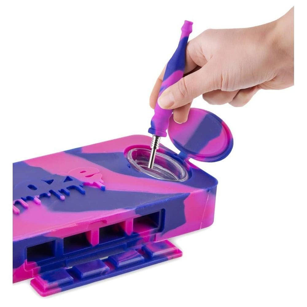 A close-up, angled view shows a hand opening the Ooze Slugger Silicone Dugout, revealing its interior compartment.