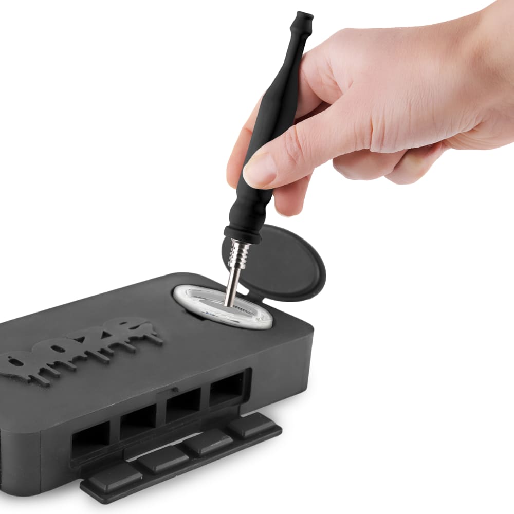 A hand opens the black Ooze Slugger Silicone Dugout, revealing the storage space inside the compact container.