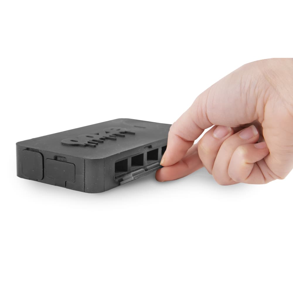 A hand holds the black Ooze Slugger Silicone Dugout, showcasing its compact size and smooth, rounded design.