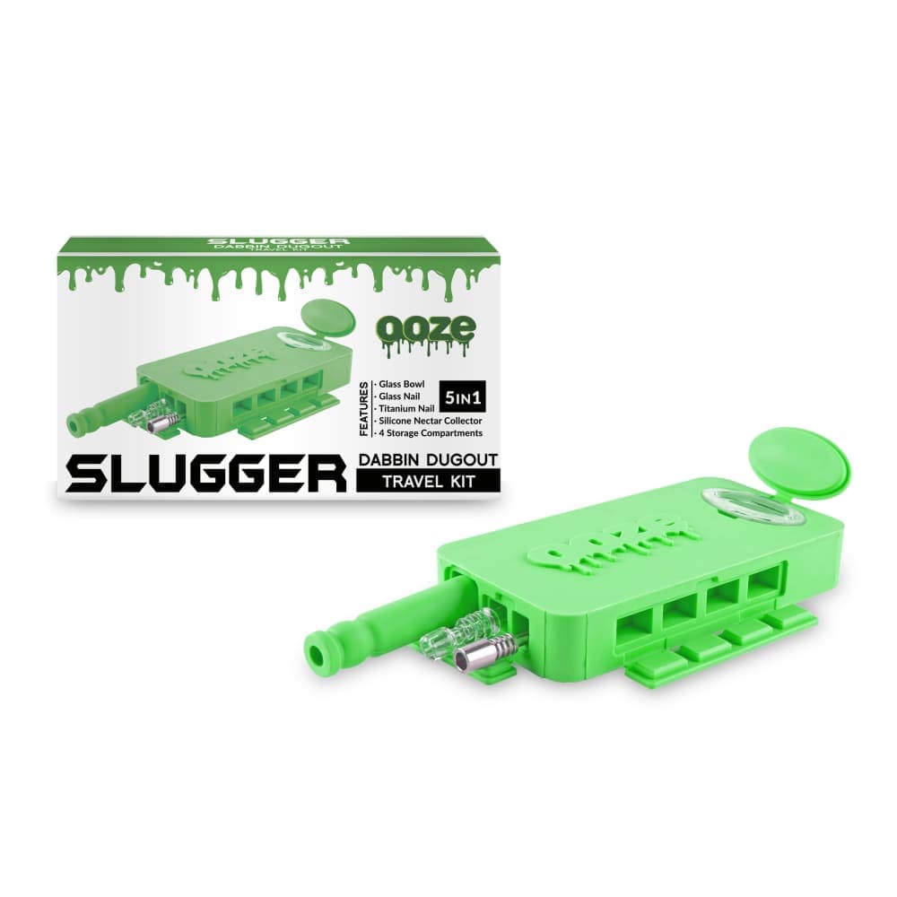 A close-up of the Ooze Slugger Silicone Dugout, showcasing its black and green design against a plain white background.