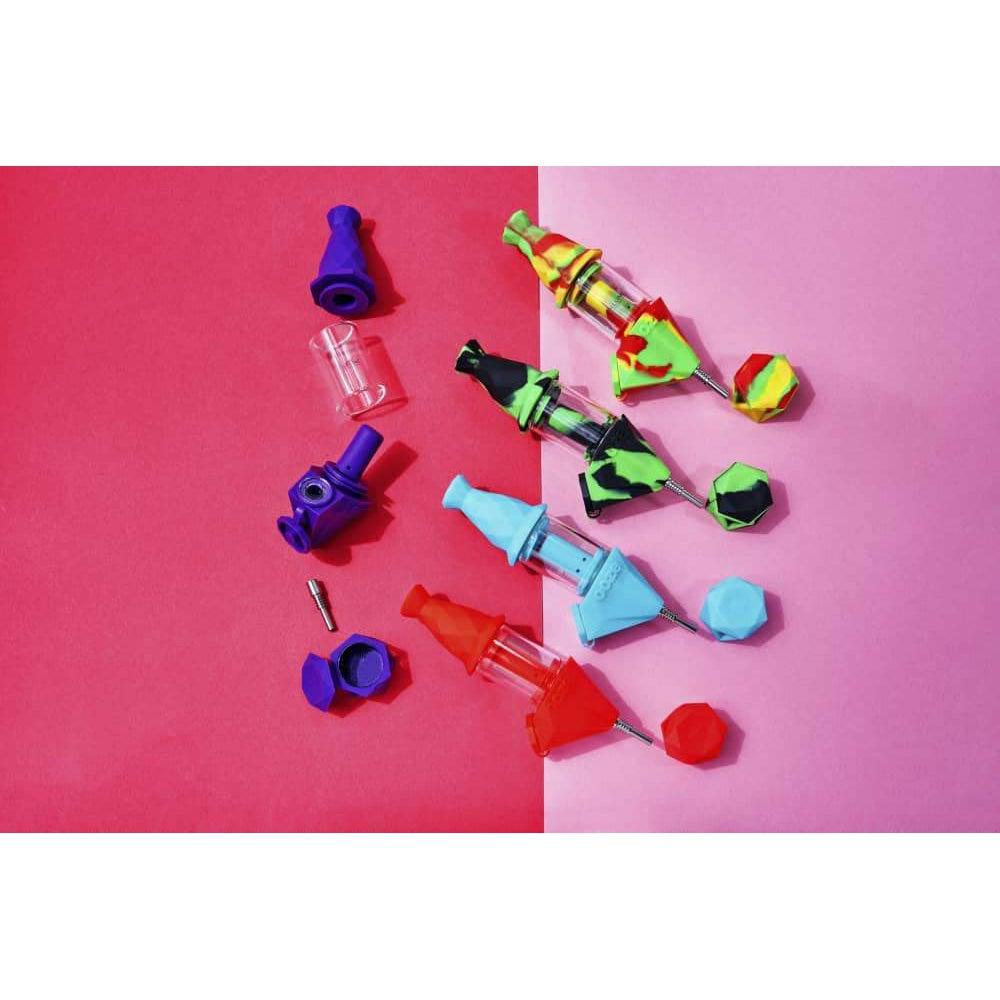 An overhead shot displays the Ooze Bectar Silicone Water Pipe and Concentrate Straw alongside its components on a vibrant pink surface.