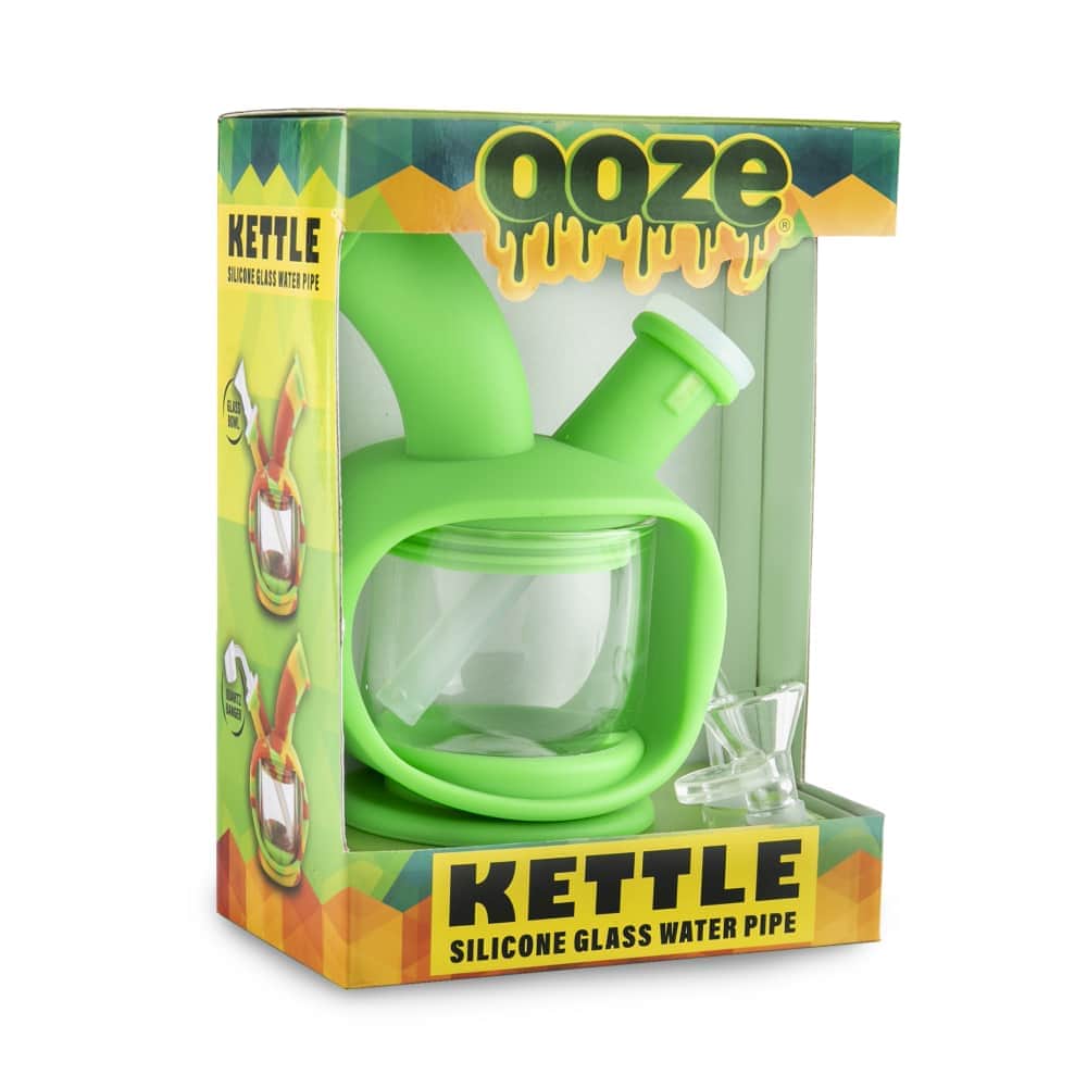 Front view of the Ooze Kettle Silicone Bubbler, showing its clear glass construction and compact size in branded packaging.
