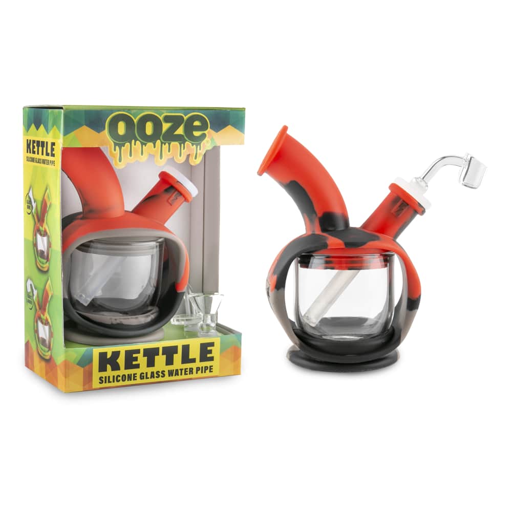 Front view of the Ooze Kettle Silicone Bubbler, a small, clear bubbler with a rounded shape and black accents, presented in its packaging.