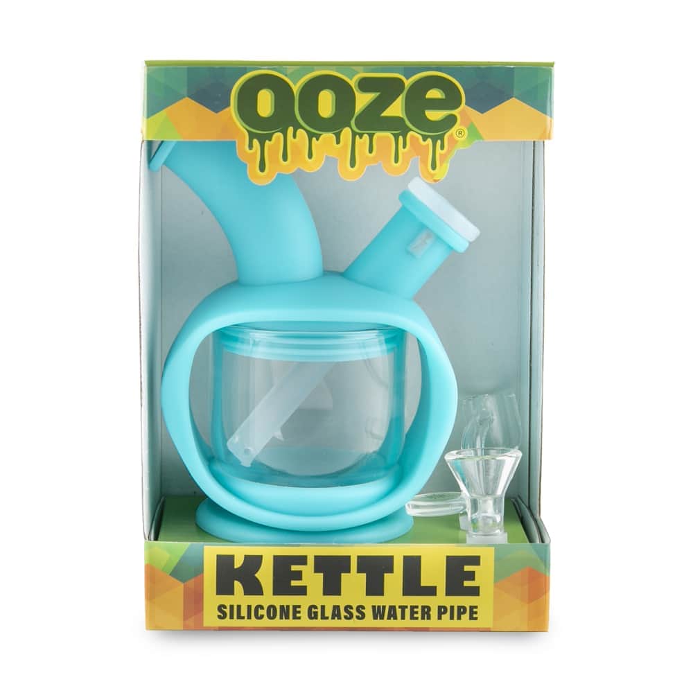 Front view of the Ooze Kettle Silicone Bubbler, a compact, clear bubbler displayed against a vibrant green and white background.