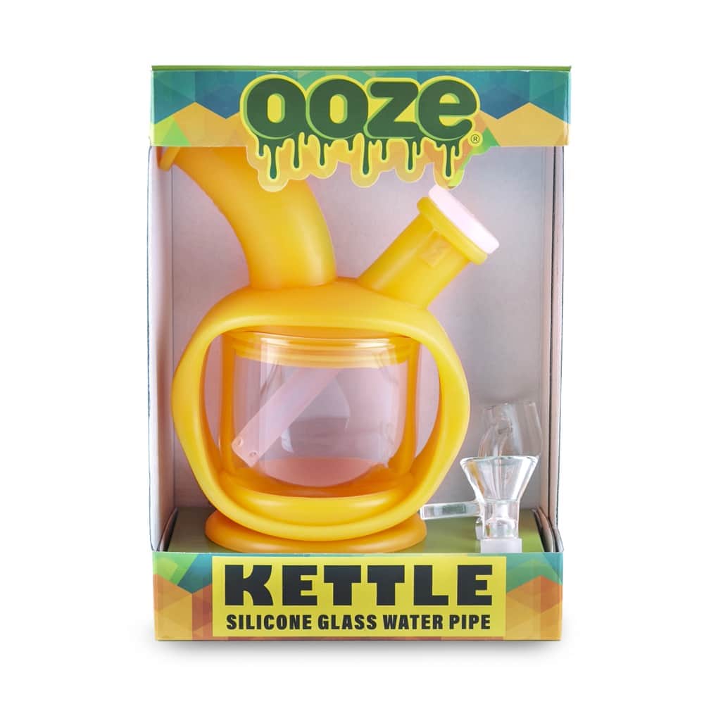 Front view of the Ooze Kettle Silicone Bubbler, displaying a clear, rounded glass bubbler against a vibrant green background.