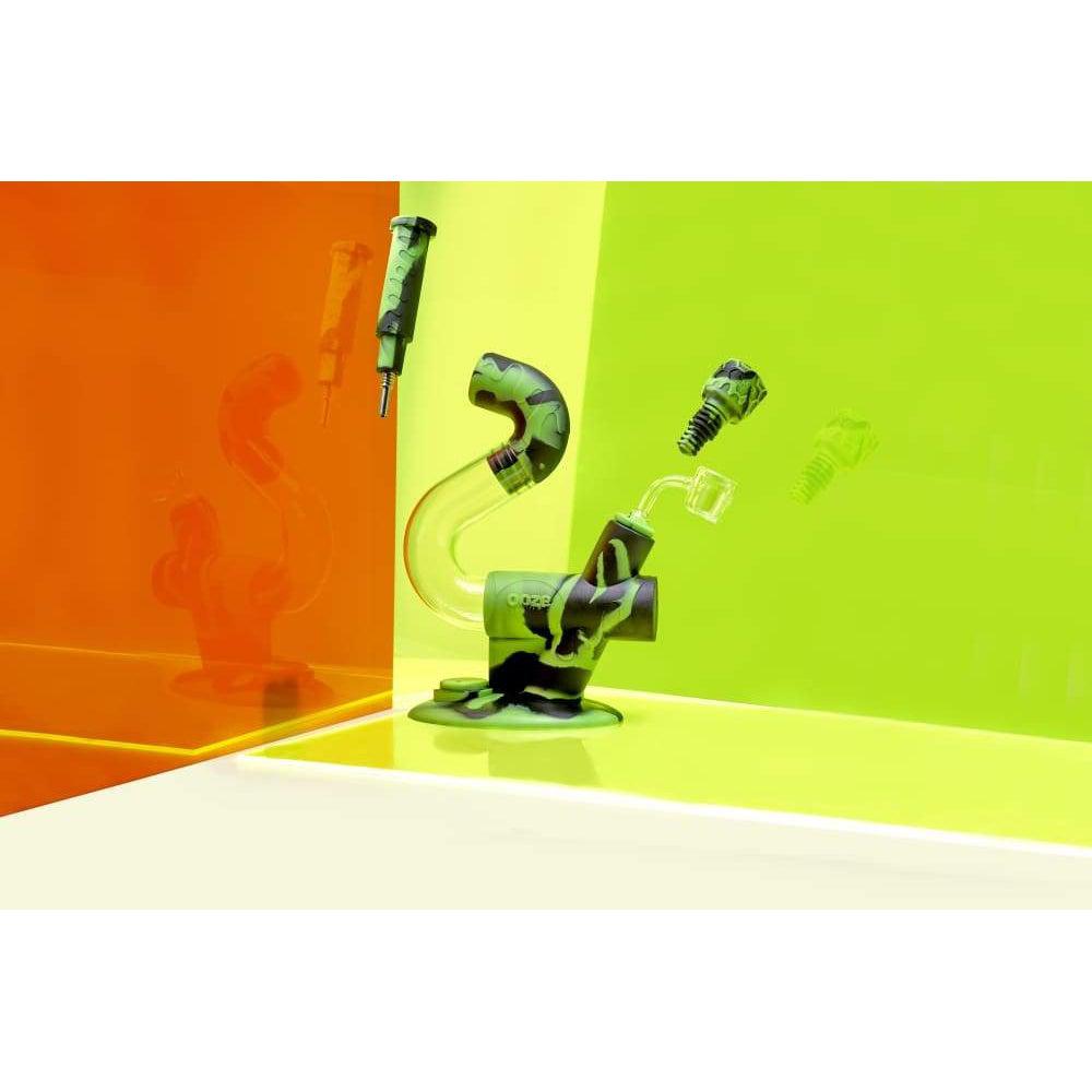 A vibrant, angled view showcases the Ooze Swerve Silicone Water Pipe against a colorful, geometric background.