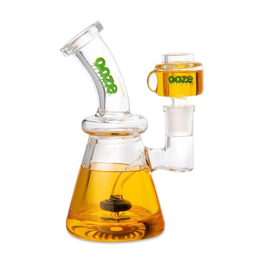 A three-quarter view of the Ooze Glyco Bong Glycerin Chilled Glass Water Pipe, showcasing its clear glass and rounded design.