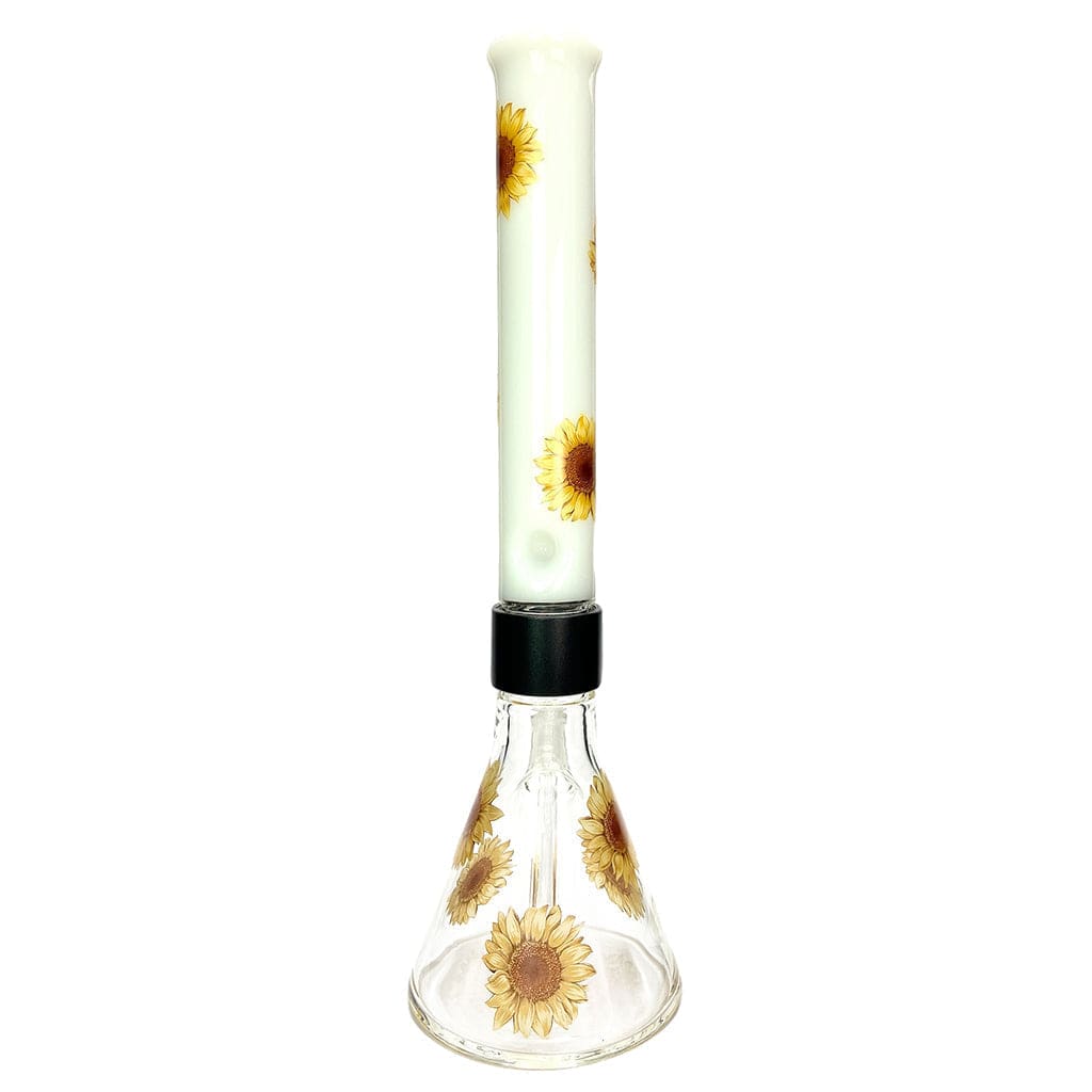 Straight-on view of the Prism Sunflower Beaker Single Stack showing a clear glass beaker base and tall white neck decorated with repeated yellow sunflower motifs.