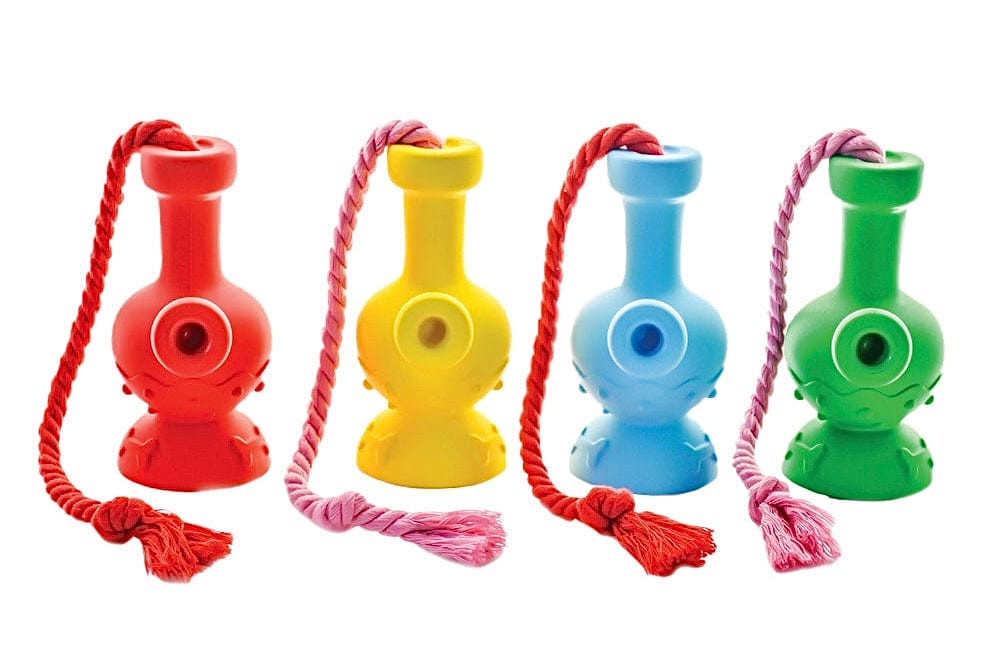 Front-facing row of four colorful Tug & Toke pieces (red, yellow, blue, green) with braided cords draped over each on a white background