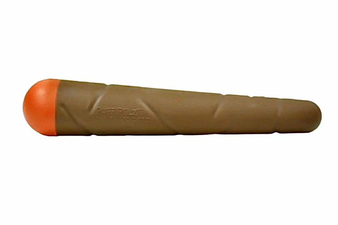 Side profile of the brown rubber training dummy with an orange rounded tip, labeled Doggie Doob, on a white background