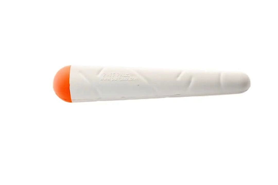 Side view of the white-and-orange Doggie Doob on a white background, showing its rounded orange cap and textured body.