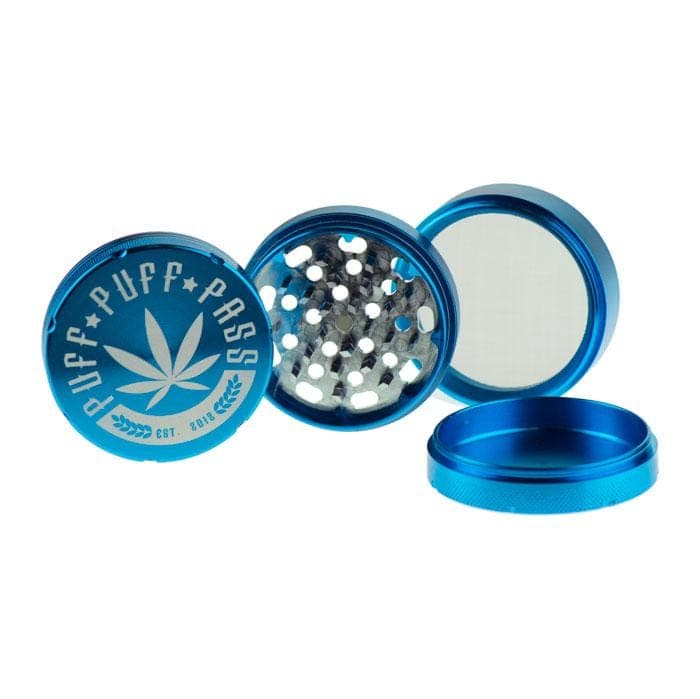 A top-down view of the 3 Stage 62mm Aluminum Grinder open, revealing multiple tiers inside the metallic silver device.