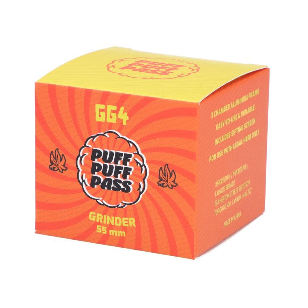 Three-quarter view of the orange and yellow Puff Puff Pass GG4 55mm 3-Stage Grinder retail box showing bold logo, stylized leaves, and sunburst graphics.