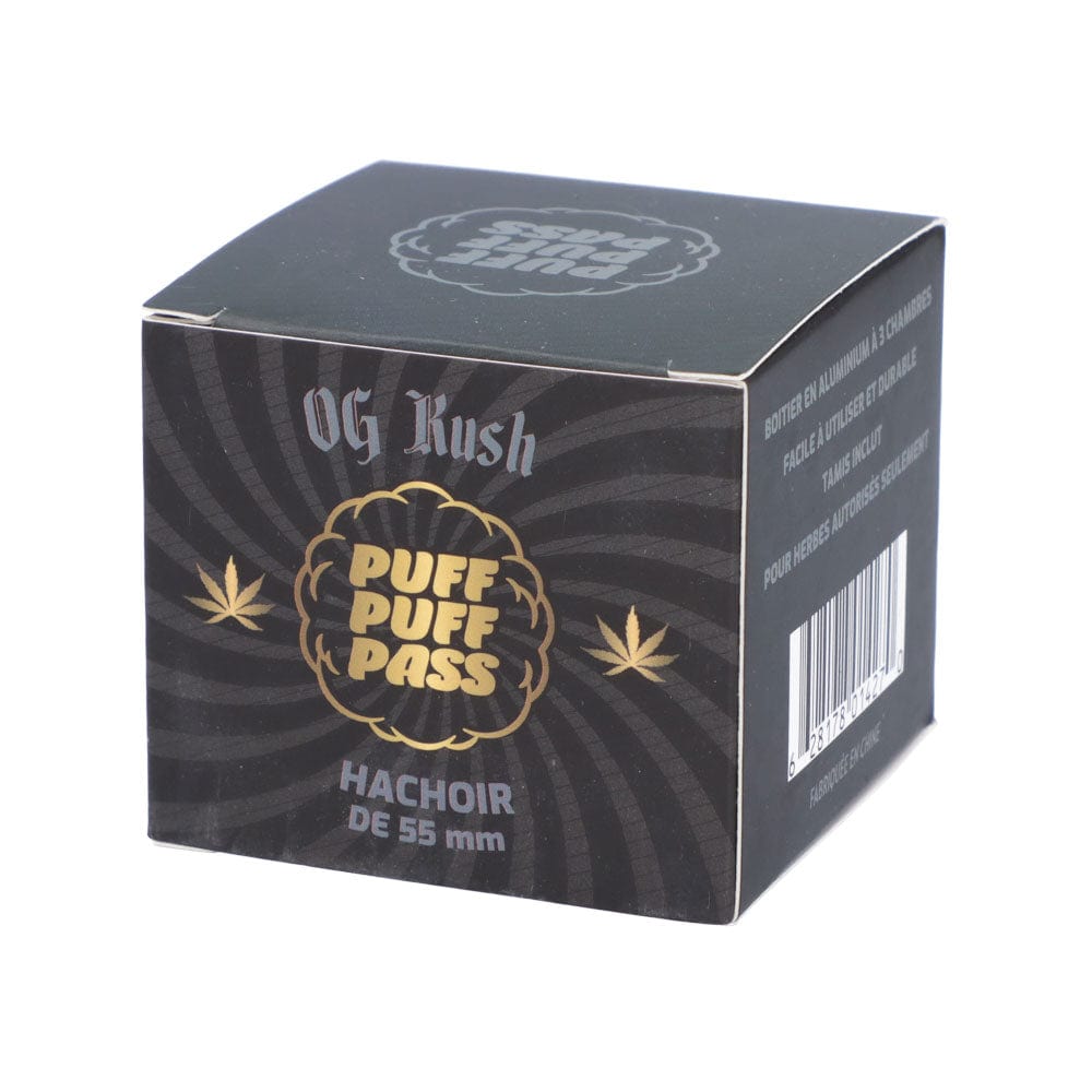 Three-quarter view of the Puff Puff Pass OG Kush 55mm 3-Stage Grinder box showing black packaging with gold logo and spiral background.