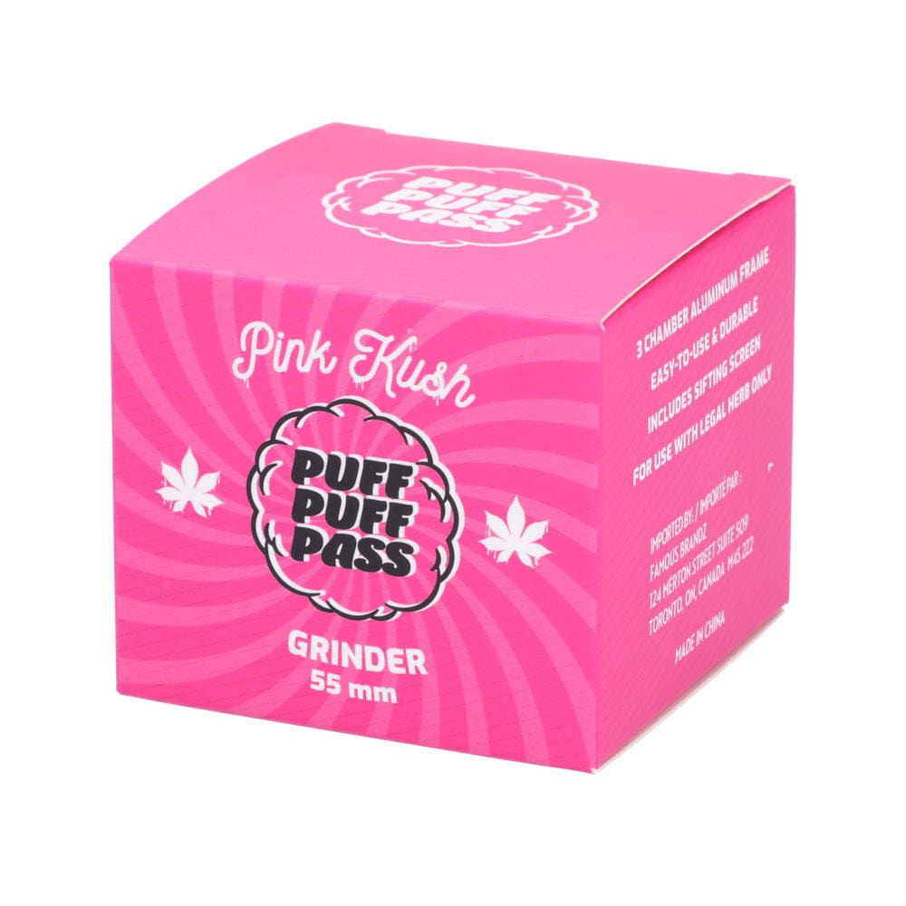 Three-quarter view of a bright pink Puff Puff Pass Pink Kush 55mm 3-Stage Grinder box with bold logo and white text.