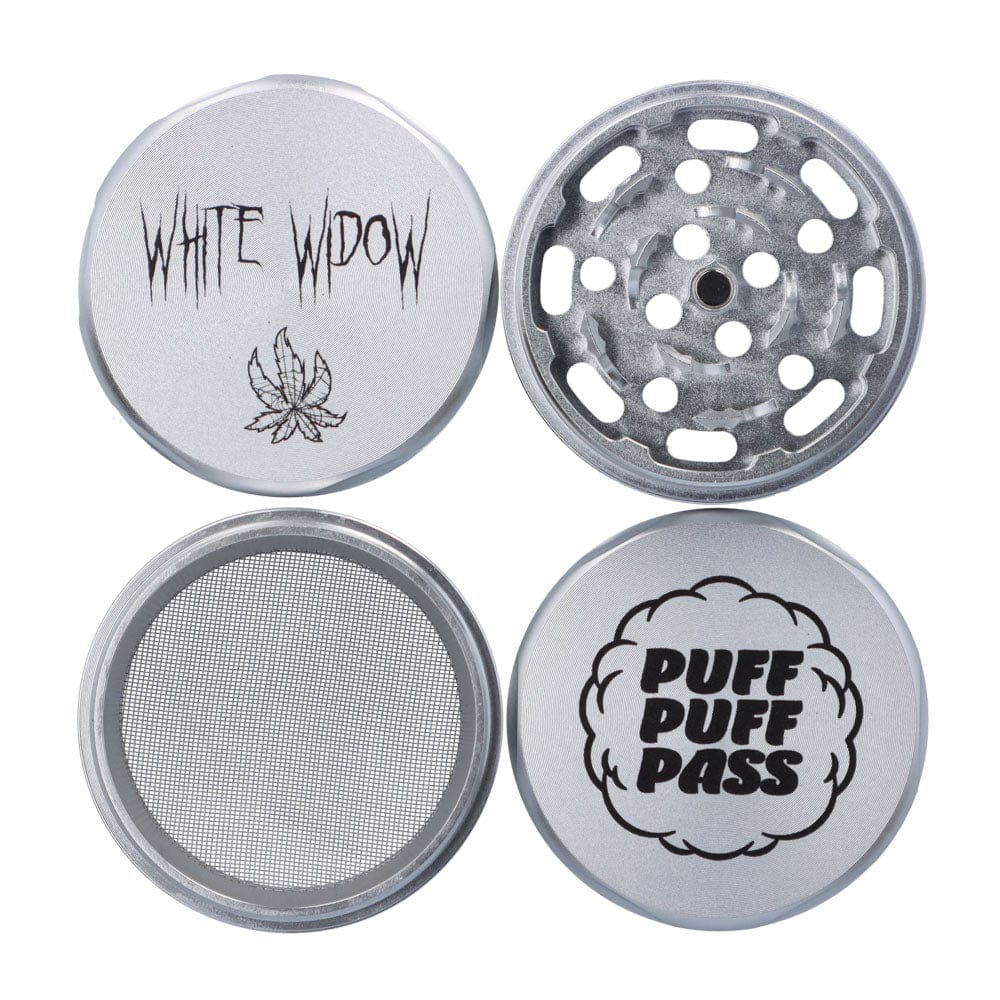 Top-down view of the silver Puff Puff Pass White Widow 55mm 3-Stage Grinder showing its four separated pieces, a toothy grinding plate, mesh screen, and lids printed "WHITE WIDOW" and "PUFF PUFF PASS".