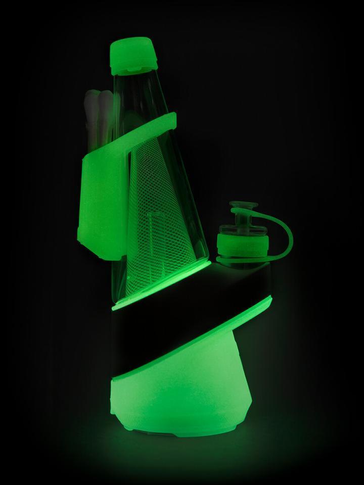 A brightly lit, angled view of the Puffco Peak - Neon Lightning, showcasing its disassembled components against a dark background.