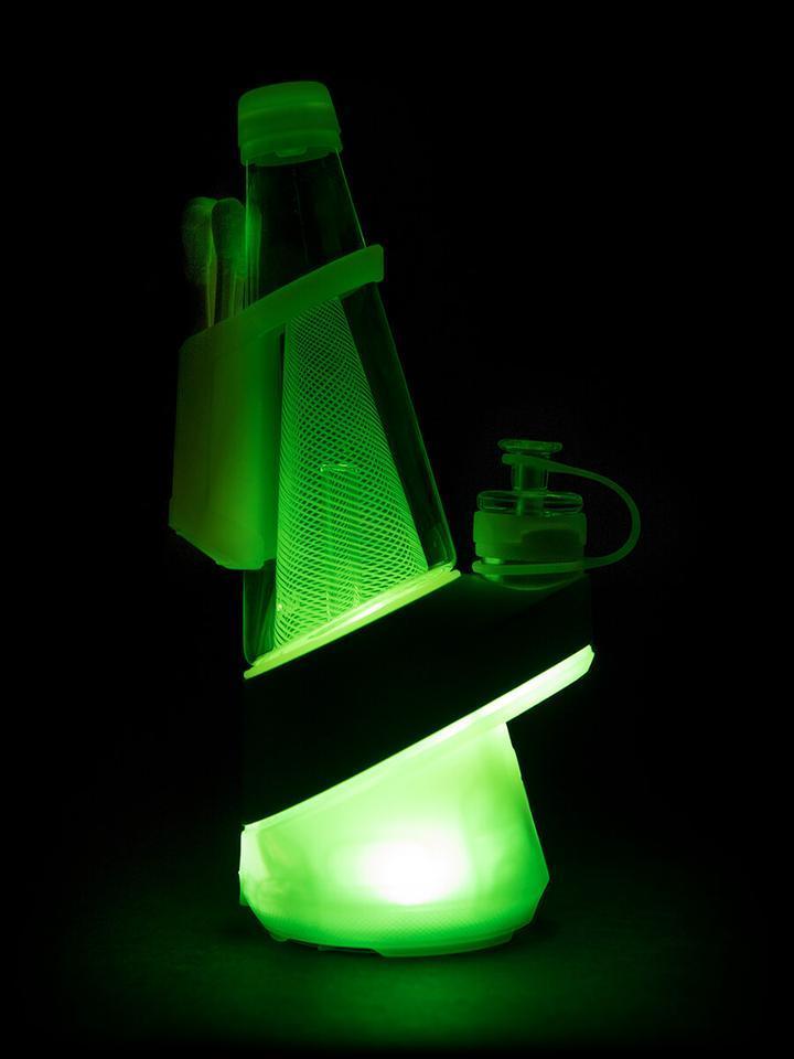 A glowing, front view of the Puffco Peak - Neon Lightning, showcasing its illuminated, rounded base and sleek design.