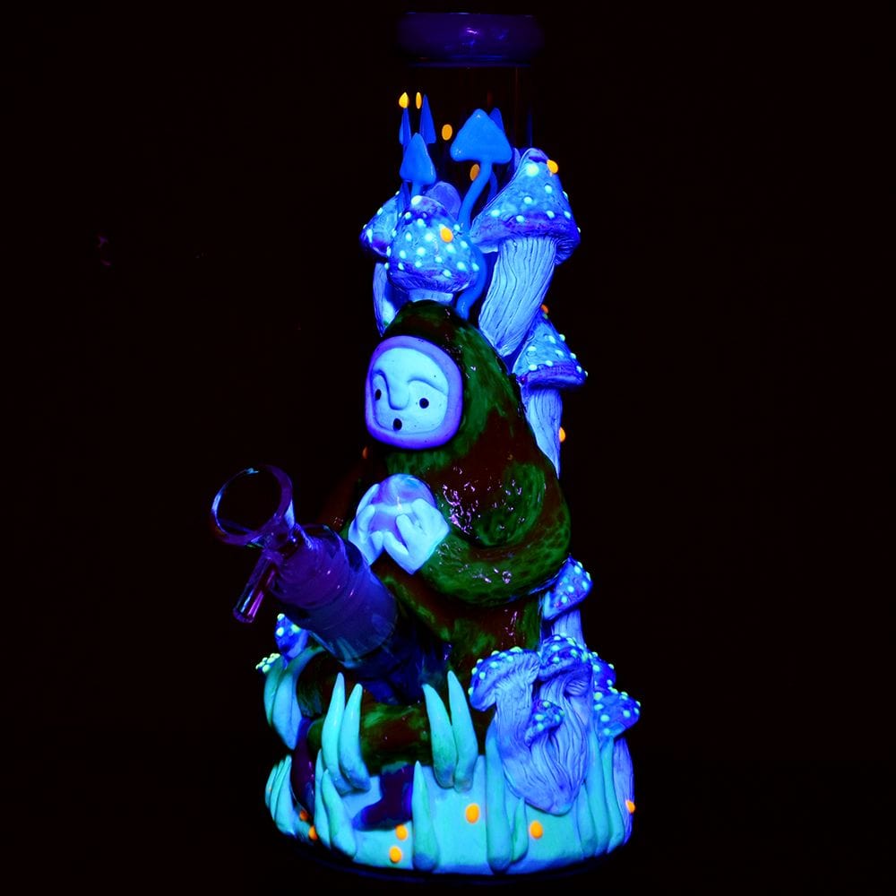 Front view of the Pulsar Artist Series Glow Beaker Water Pipe, featuring glowing blue mushroom-shaped accents on its glass body.