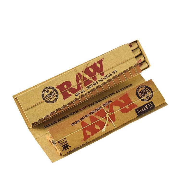 Close-up of "Raw "Masterpiece" Papers + Prerolled Tips" stacked, displaying the branded packaging and paper design.