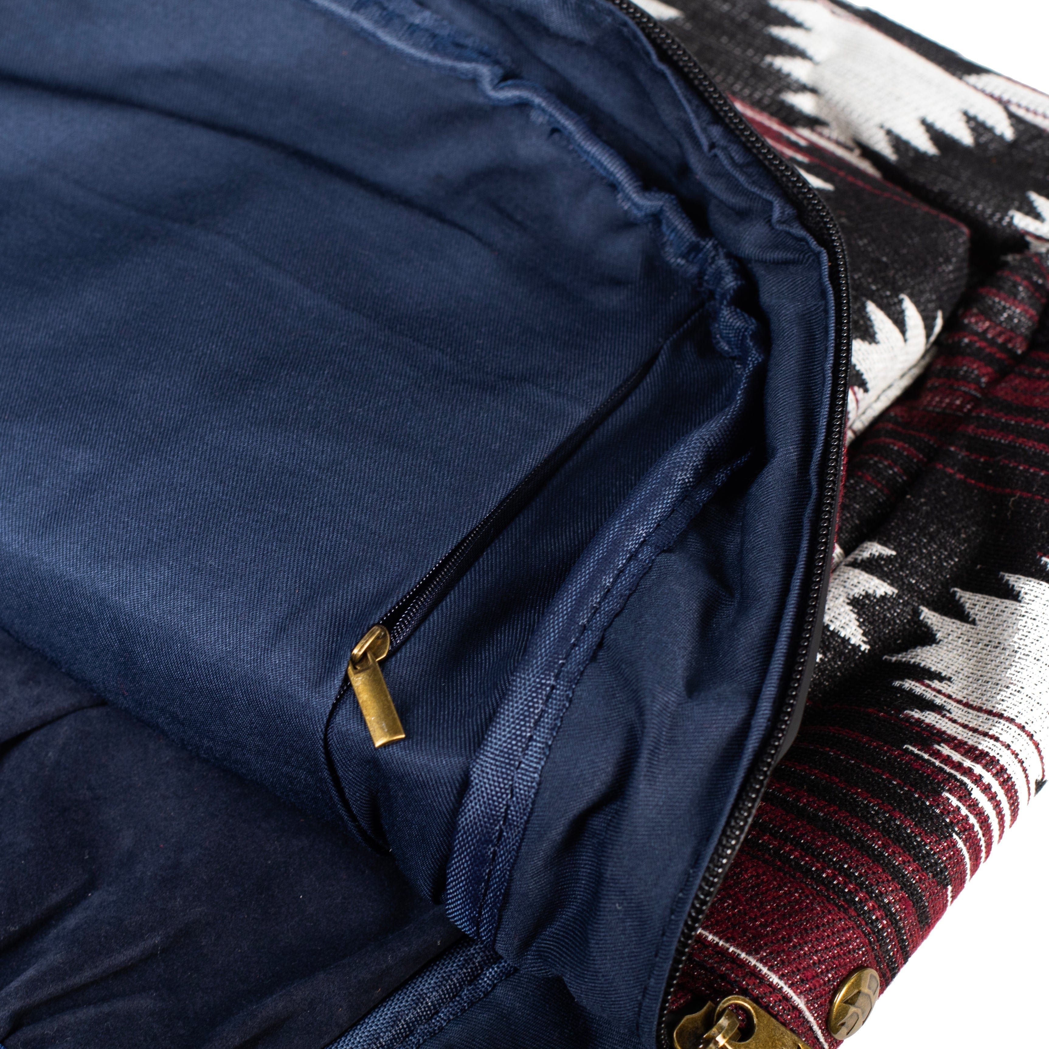 Close-up view of the interior lining of The Explorer - Smell Proof Backpack, showcasing a dark blue fabric with a partially visible patterned exterior.