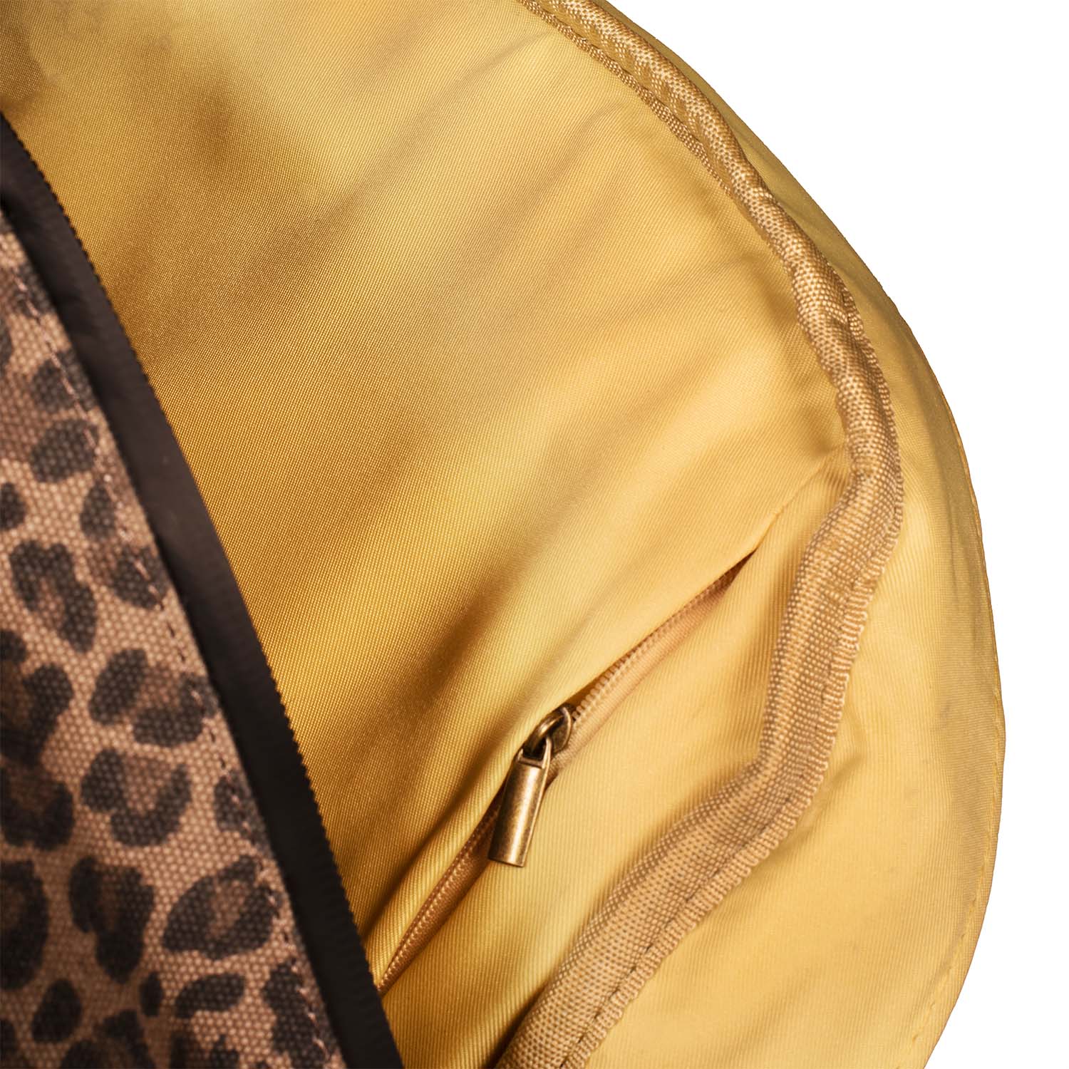 Close-up of The Explorer - Smell Proof Backpack’s interior lining, showing a textured, golden fabric with a visible zipper pull.