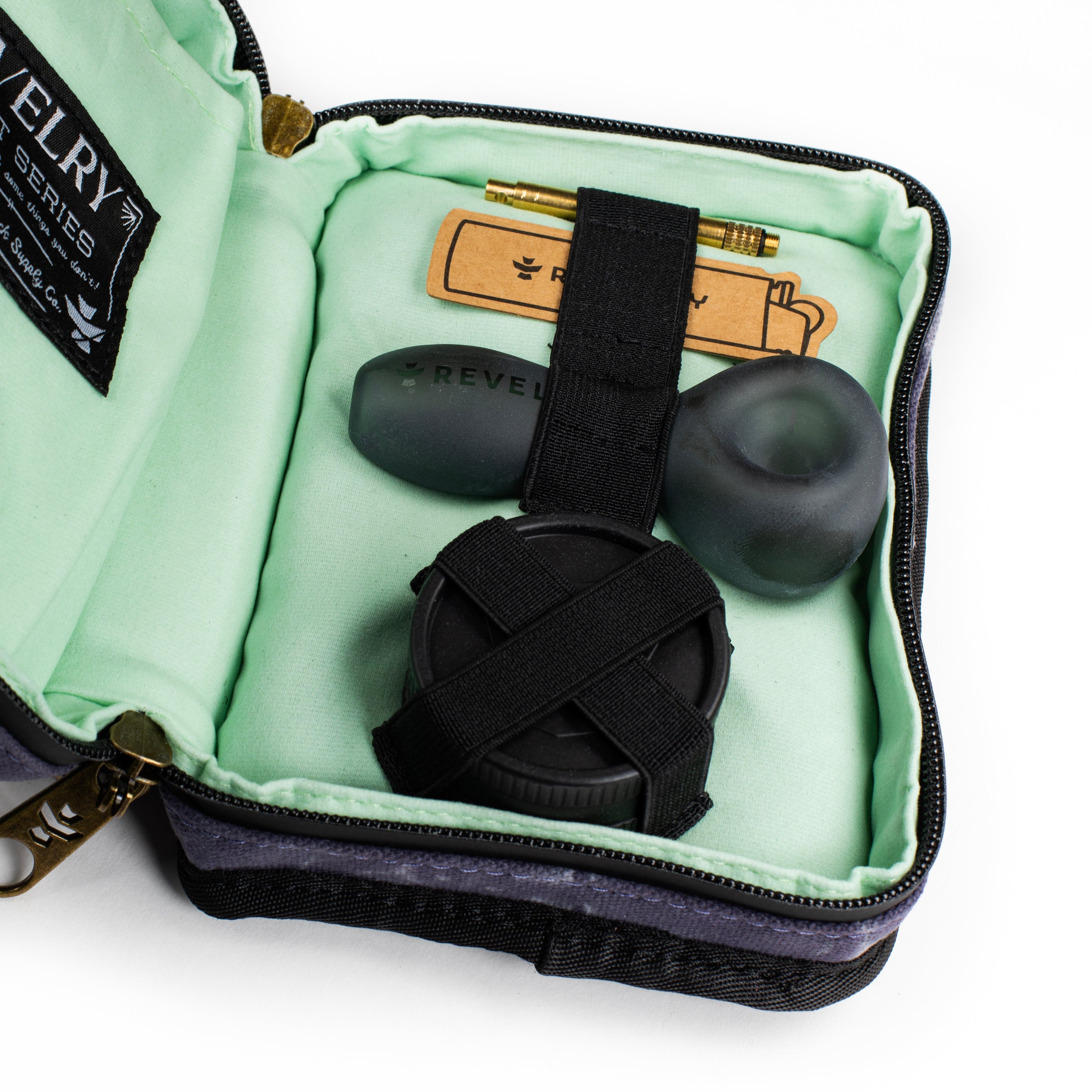 Overhead view of The Pipe Kit - Smell Proof Kit, open to reveal a black carrying case with a green interior.