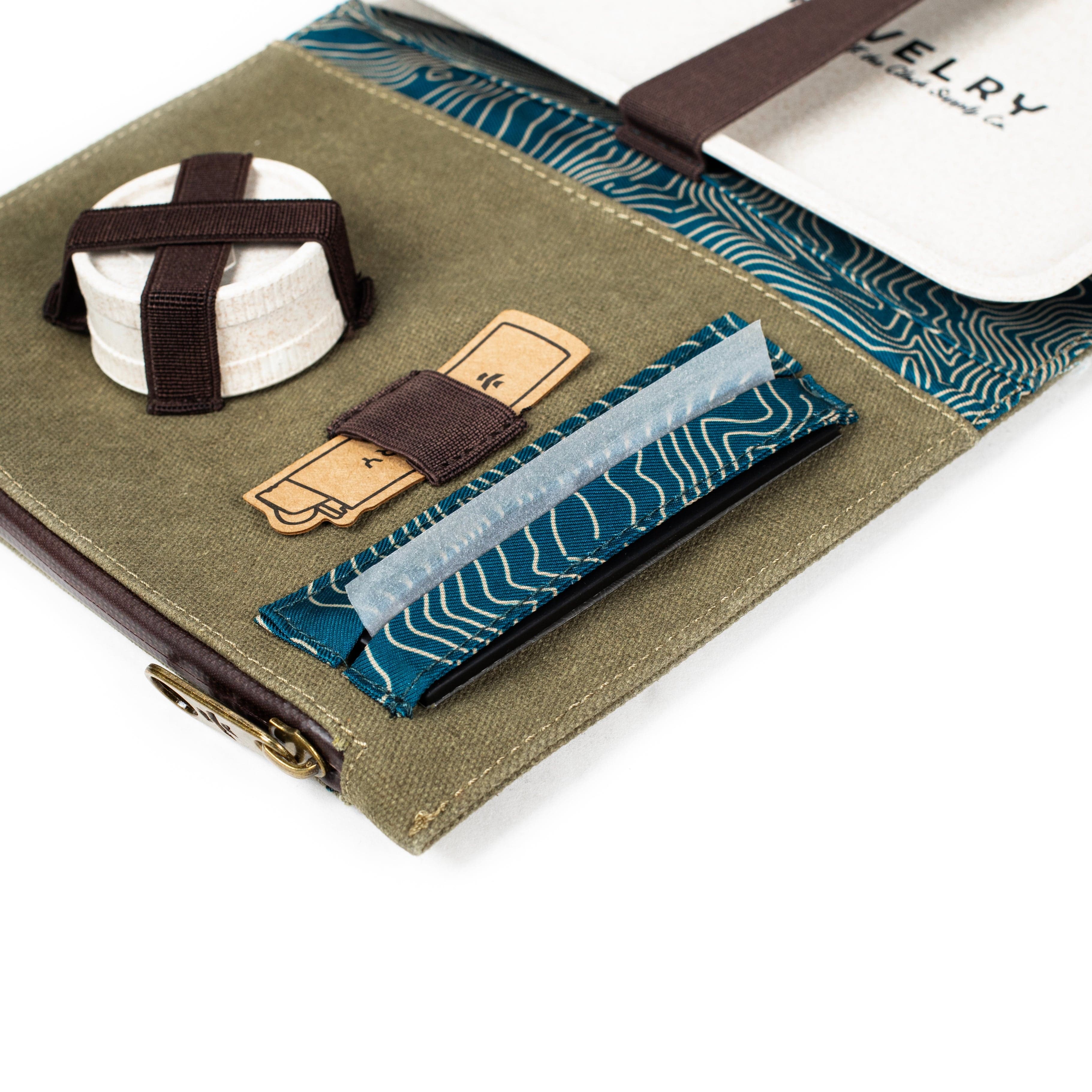 A close-up of The Rolling Kit - Smell Proof Kit, with a tightly wrapped package and the kit's patterned label prominently displayed.