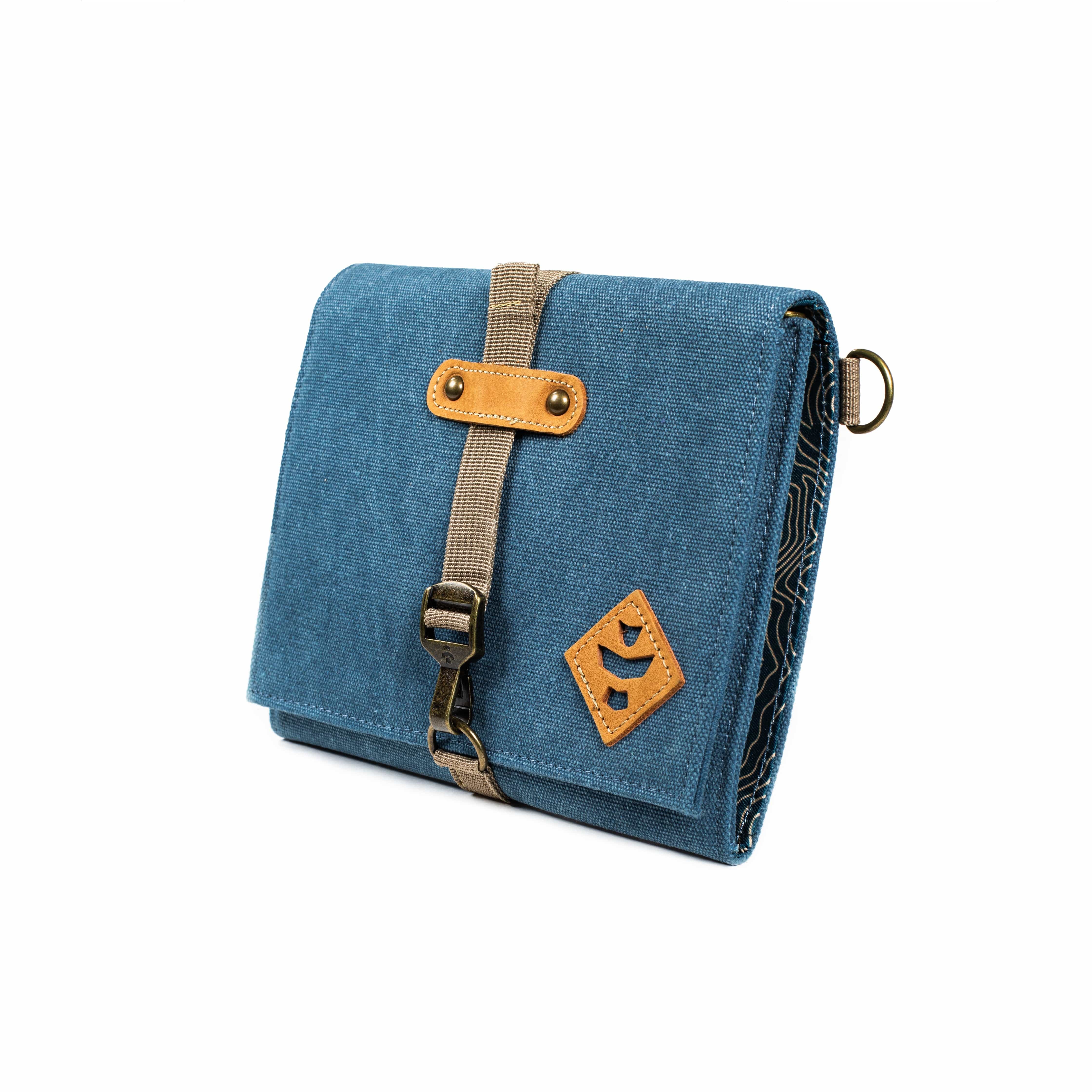 Front view of The Rolling Kit - Smell Proof Kit, a blue, zippered pouch with a tan strap and buckle, angled slightly on a neutral background.