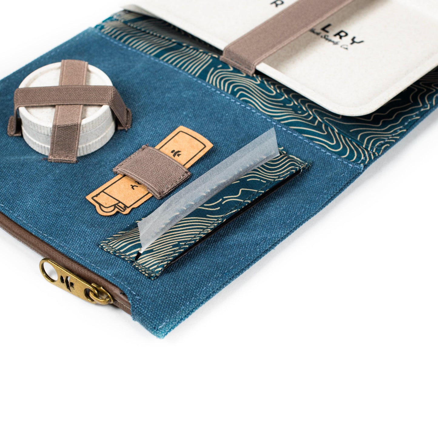 Close-up angled view of The Rolling Kit - Smell Proof Kit, showcasing a navy and charcoal kit with a branded leather patch.