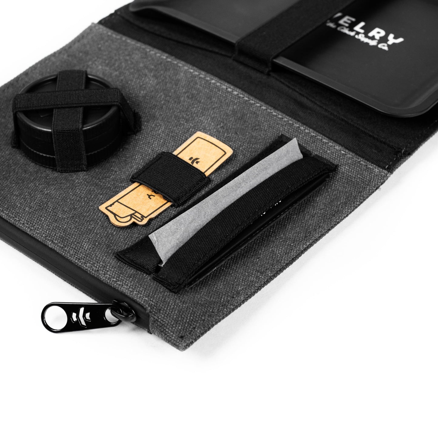 Overhead view of The Rolling Kit - Smell Proof Kit, showcasing its folded, dark gray fabric interior and zipped closure.