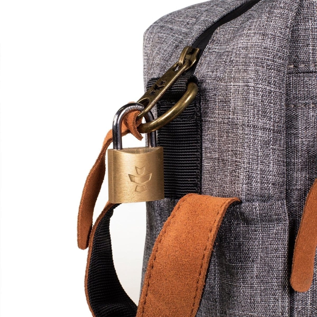 Close-up of The Stowaway - Smell Proof Toiletry Kit's handle, showing dark gray fabric and a bronze metal clasp.